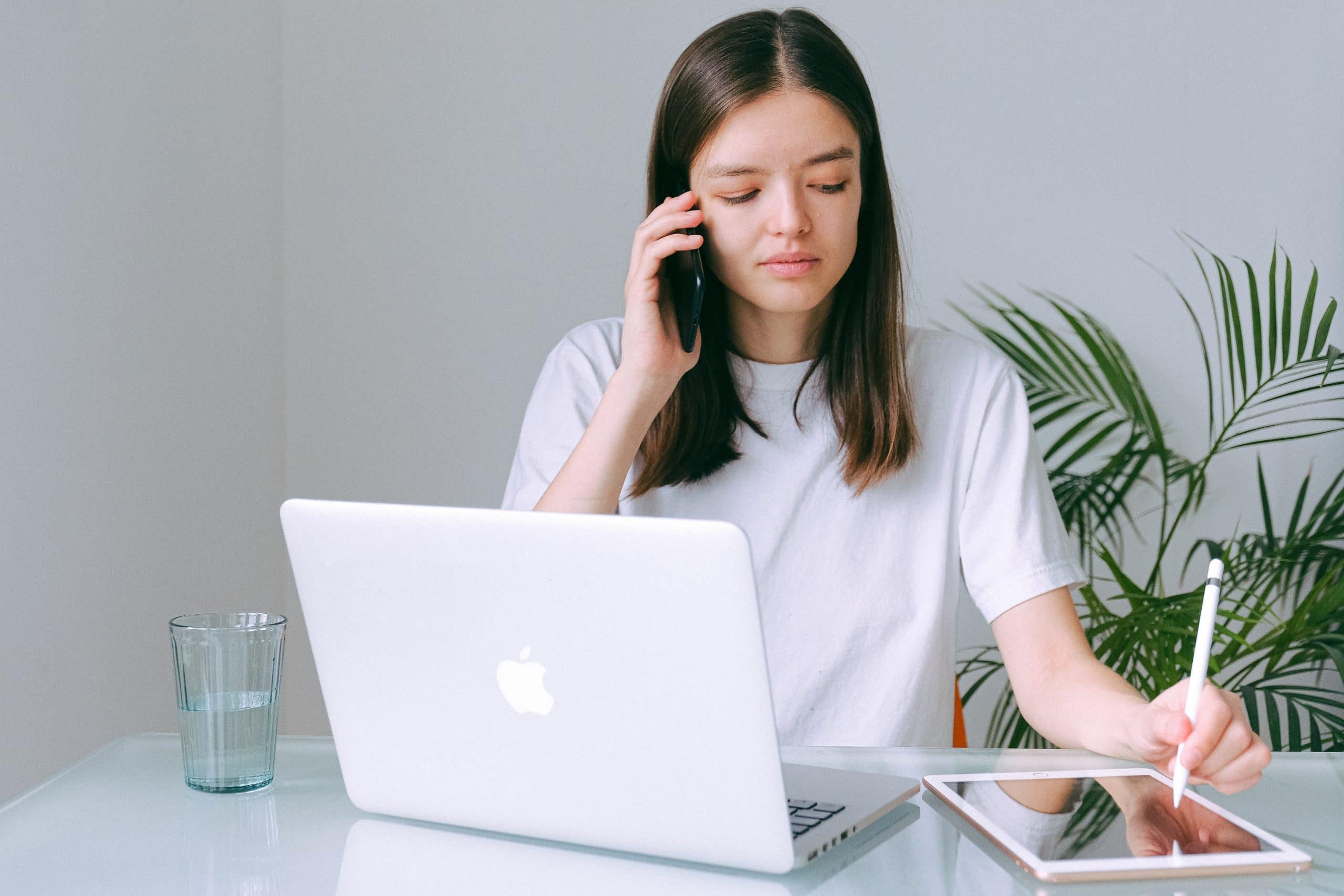 woman in white shirt on the phone