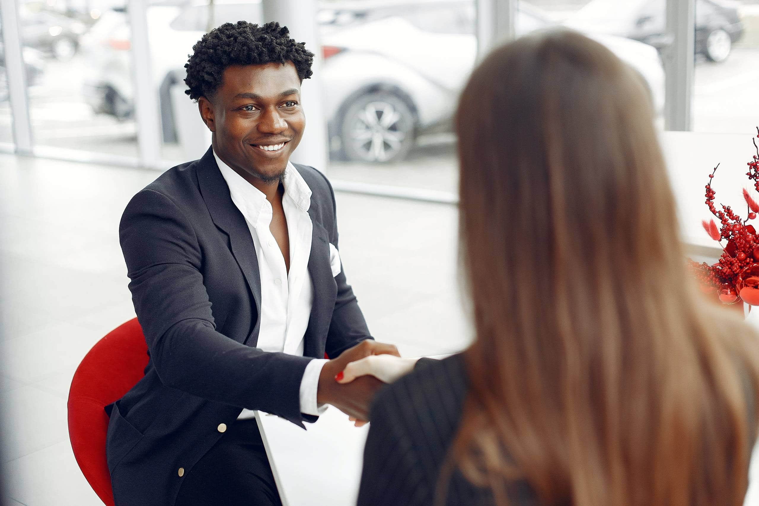 man and woman shaking hands going over the lemon law process in a dealership