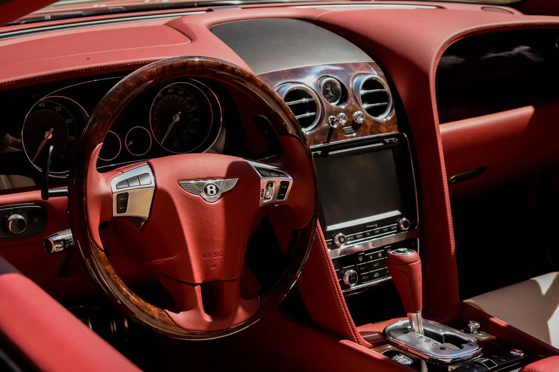 red steering wheel inside a bentley
