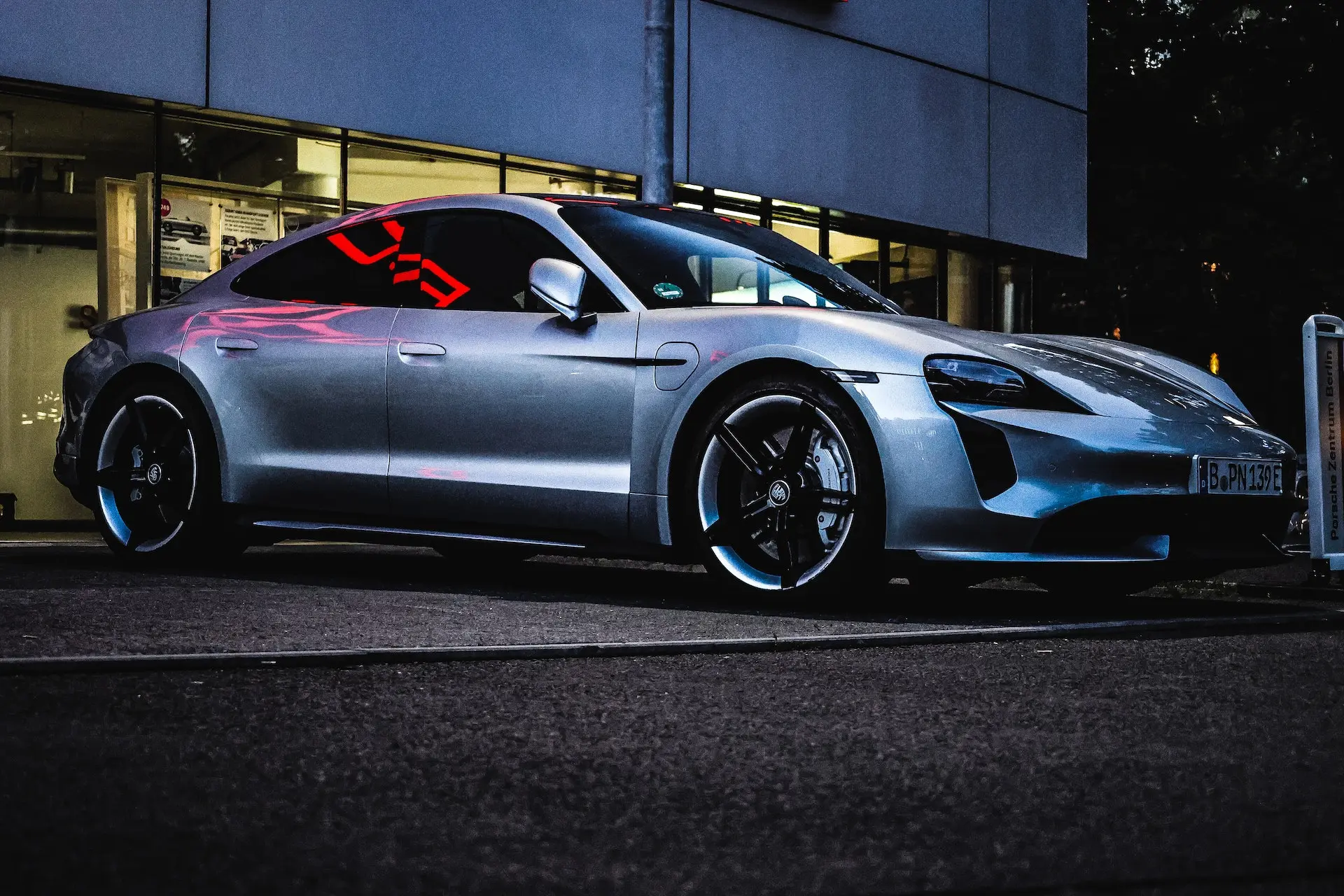 porsche parked in front of a building