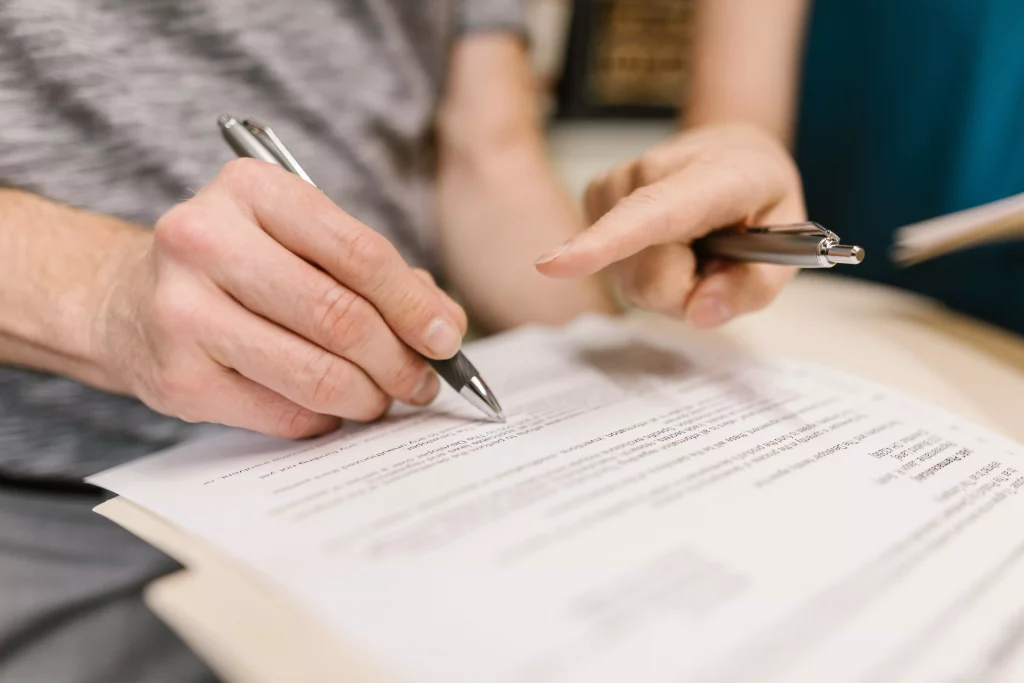 person signing a document